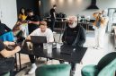 Ilustrasi anggota koperasi sedang berinteraksi dengan aplikasi digital di laptop dan ponsel mereka, menunjukkan kemudahan akses serta efisiensi dalam pengelolaan koperasi modern. Gambar ini menggambarkan bagaimana teknologi dapat memfasilitasi komunikasi dan transaksi antar anggota serta pengurus koperasi.