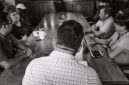 Suasana Rapat Anggota Tahunan (RAT) yang kondusif, menampilkan para anggota koperasi berdiskusi dan memberikan suara untuk memutuskan berbagai agenda penting. Pertemuan ini adalah cerminan nyata dari demokrasi internal dalam sebuah koperasi.