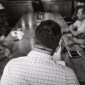 Suasana Rapat Anggota Tahunan (RAT) yang kondusif, menampilkan para anggota koperasi berdiskusi dan memberikan suara untuk memutuskan berbagai agenda penting. Pertemuan ini adalah cerminan nyata dari demokrasi internal dalam sebuah koperasi.